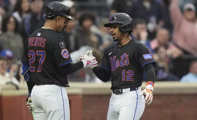 New York Mets' Francisco Lindor (12) celebrates with teammate Mark Vientos (27) after hitting a home run during the first inning of a baseball game Friday, May 30, 2025, in New York. (AP Photo/Frank Franklin II)