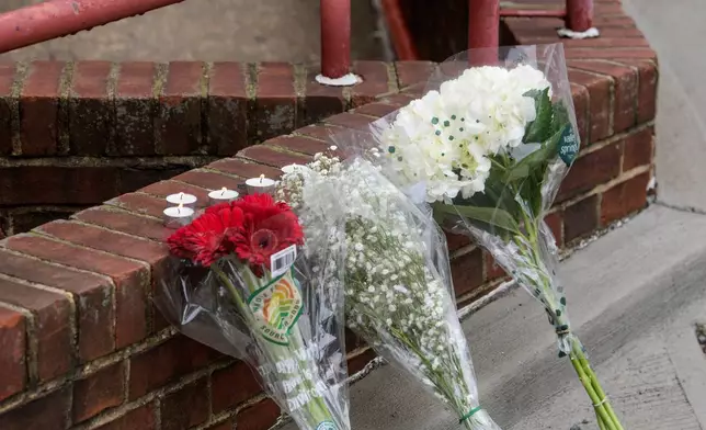 Flowers and candles are pictured as law enforcement work the scene after two staff members of the Israeli Embassy in Washington were shot and killed outside the Capital Jewish Museum, Thursday, May 22, 2025, in Washington. (AP Photo/Rod Lamkey, Jr.)