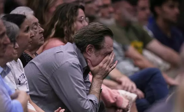 People at the Jewish Community Center of Greater Kansas City mourn Sarah Milgrim and Yaron Lischinsky, Israeli Embassy staff members who were shot and killed while leaving an event at a Jewish museum in Washington, Thursday, May 22, 2025, in Overland Park, Kan. (AP Photo/Charlie Riedel)