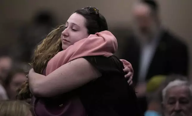 People at the Jewish Community Center of Greater Kansas City morn Sarah Milgrim and Yaron Lischinsky, Israeli Embassy staff members who were shot and killed while leaving an event at a Jewish museum in Washington, Thursday, May 22, 2025, in Overland Park, Kan. (AP Photo/Charlie Riedel)