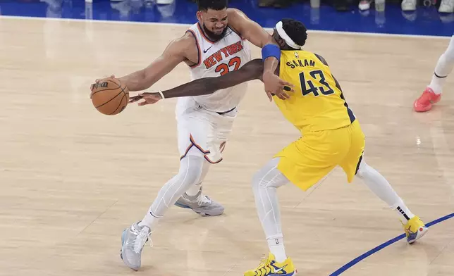 New York Knicks center Karl-Anthony Towns (32) drives against Indiana Pacers forward Pascal Siakam (43) during the third quarter of Game 5 of the NBA basketball Eastern Conference final, Thursday, May 29, 2025, in New York. (AP Photo/Frank Franklin II)