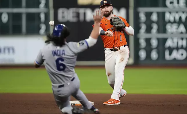 Houston Astros second baseman Brendan Rodgers (1) throws to first over Kansas City Royals' Jonathan India (6) for a double play during the fifth inning of a baseball game in Houston, Tuesday, May 13, 2025. India was out at second and Hunter Renfroe was out at first. (AP Photo/Ashley Landis)