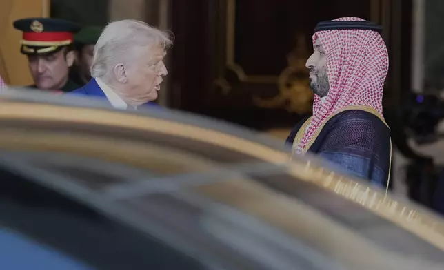 President Donald Trump speaks with Saudi Crown Prince Mohammed bin Salman as he leaves the Royal Palace after a signing ceremony with Saudi Crown Prince Mohammed bin Salman in Riyadh, Saudi Arabia, Tuesday, May 13, 2025. (AP Photo/Alex Brandon)