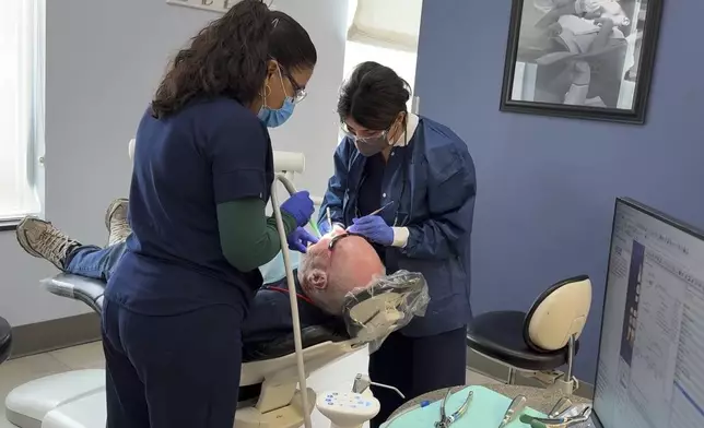 A patient receives a dental procedure at Salt Lake Donated Dental Services, a clinic serving low-income Utah residents, Monday, May 5, 2025, in Salt Lake City, Utah. (AP Photo/Hannah Schoenbaum)
