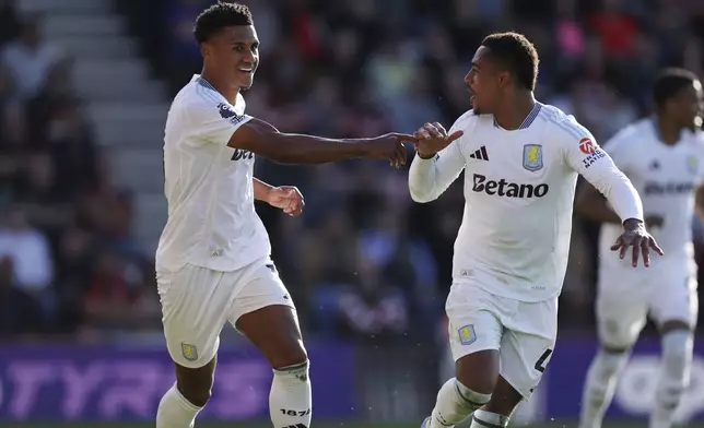 Aston Villa's Ollie Watkins, left, celebrates scoring with Jacob Ramsey during the English Premier League soccer match between Bournemouth and Aston Villa at the Vitality Stadium, Bournemouth, England, Saturday May 10, 2025. (Steven Paston/PA via AP)