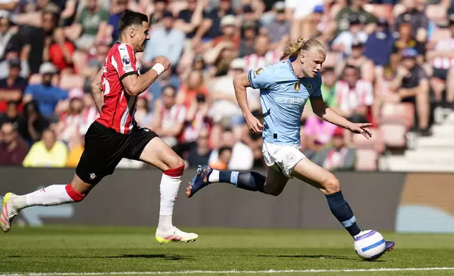 Manchester City's Erling Haaland, right, controls the ball from Southampton's Jan Bednarek during their Premier League soccer match at St Mary's Stadium, Southampton, England, Saturday May 10, 2025. (Andrew Matthews/PA via AP)