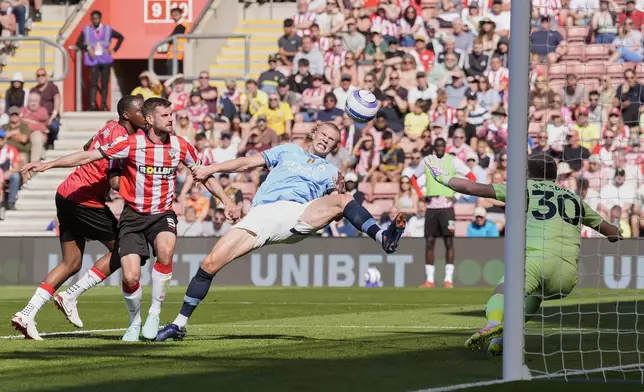 Manchester City's Erling Haaland, center, attempts a shot on goal during their Premier League soccer match at St Mary's Stadium, Southampton, England, Saturday May 10, 2025. (Andrew Matthews/PA via AP)
