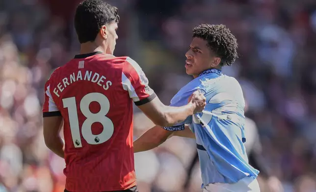 Southampton's Mateus Fernandes, left, and Manchester City's Rico Lewis exchange words during their Premier League soccer match at St Mary's Stadium, Southampton, England, Saturday May 10, 2025. (Andrew Matthews/PA via AP)