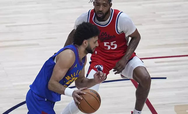 Denver Nuggets guard Jamal Murray, left, drives past Los Angeles Clippers forward Derrick Jones Jr. (55) in the first half of Game 7 of an NBA basketball first-round playoff series Saturday, May 3, 2025, in Denver. (AP Photo/David Zalubowski)