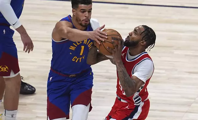 Denver Nuggets forward Michael Porter Jr. (1) stops Los Angeles Clippers forward Derrick Jones Jr., right, in the first half of Game 7 of an NBA basketball first-round playoff series Saturday, May 3, 2025, in Denver. (AP Photo/David Zalubowski)