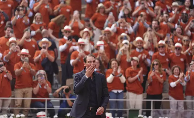 Rafa Nadal is cheered by the crowd during a farewell ceremony at center court Philippe-Chatrier, at the Roland-Garros stadium, in Paris, Sunday May 25, 2025. (AP Photo/Lindsey Wasson)