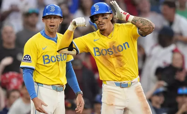 Boston Red Sox left fielder Jarren Duran gestures after his seventh inning triple against the Minnesota Twins, Saturday, May 3, 2025, in Boston. (AP Photo/Robert F. Bukaty)