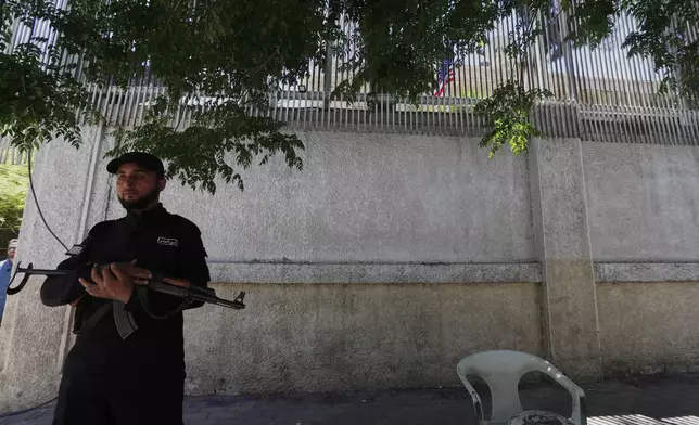 A member of the security forces stands guard outside the U.S. ambassador's residence as U.S. Ambassador to Turkey and Special Envoy to Syria Tom Barrack arrives to inaugurate the long-shuttered compound in Damascus, Syria, Thursday, May 29, 2025. (AP Photo/Omar Sanadiki)