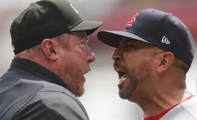 St. Louis Cardinals manager Oliver Marmol, right, reacts after being ejected by umpire Bruce Dreckman during the eighth inning of the first baseball game of a doubleheader against the Cincinnati Reds, Wednesday, April 30, 2025, in Cincinnati. (AP Photo/Jeff Dean)