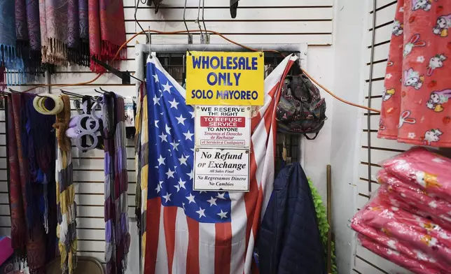 FILE - An American flag hangs in a store owned by Kyung Sook Im in the Toy District of Los Angeles, Wednesday, April 9, 2025, where the majority of the merchandise is imported from China. (AP Photo/Jae C. Hong, File)
