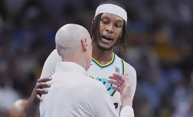 Indiana Pacers center Myles Turner talks to head coach Rick Carlisle in the second half of Game 4 against the Cleveland Cavaliers in the Eastern Conference semifinals of the NBA basketball playoffs in Indianapolis, Sunday, May 11, 2025. (AP Photo/Michael Conroy)