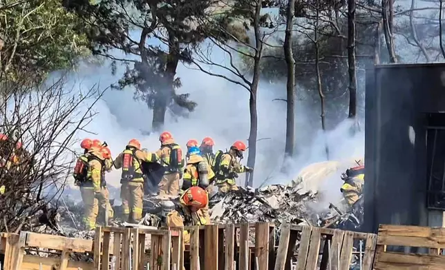 South Korean firefighters work at the scene of a South Korean navy plane's crash in Pohang, South Korea, Thursday, May 29, 2025. (Son Dae-sung/Yonhap via AP)
