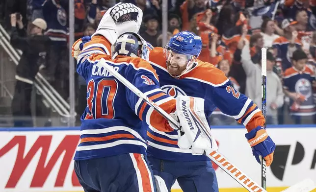 Edmonton Oilers goalie Calvin Pickard (30) and Connor Brown (28) celebrate the win over the Los Angeles Kings during NHL playoff action in Edmonton on Thursday, May 1, 2025. (Jason Franson/The Canadian Press via AP)