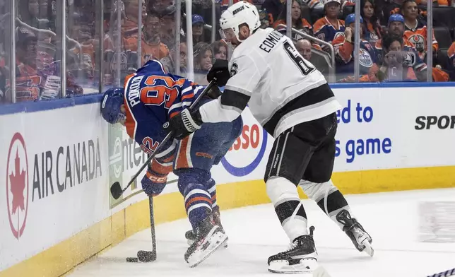 Los Angeles Kings' Joel Edmundson (6) checks Edmonton Oilers' Vasily Podkolzin (92) during the second period of an NHL hockey game in Edmonton, Alberta, Thursday, May 1, 2025. (Jason Franson/The Canadian Press via AP)