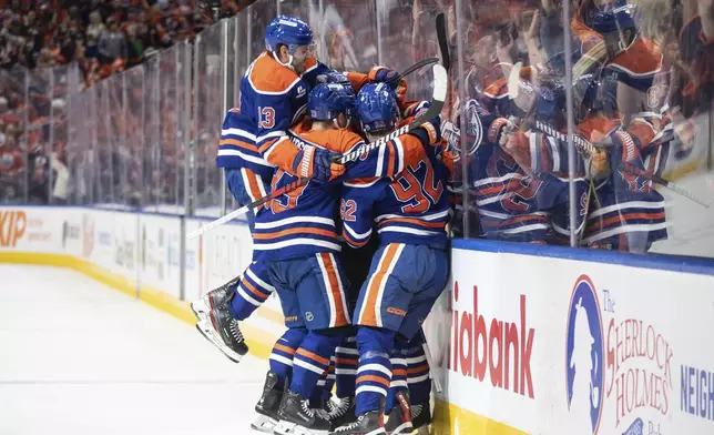Edmonton Oilers players celebrate Darnell Nurse's goal against the Los Angeles Kings during the second period of an NHL hockey game in Edmonton, Alberta, Thursday, May 1, 2025. (Jason Franson/The Canadian Press via AP)