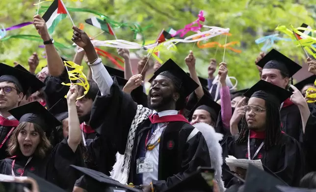 Students celebrate during commencement ceremonies at Harvard University, Thursday, May 29, 2025, in Cambridge, Mass. (AP Photo/Charles Krupa)