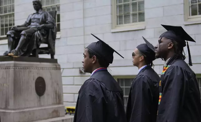 Graduating students walk through Harvard Yard during commencement ceremonies at Harvard University, Thursday, May 29, 2025, in Cambridge, Mass. (AP Photo/Charles Krupa)