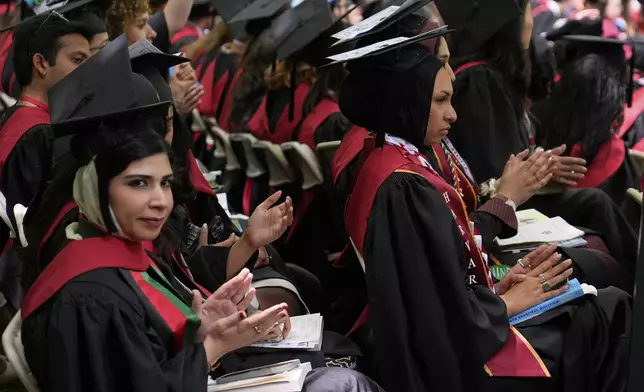 Graduating students applaud during commencement ceremonies at Harvard University, Thursday, May 29, 2025, in Cambridge, Mass. (AP Photo/Charles Krupa)