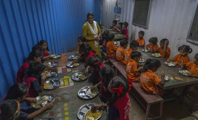 Students eat lunch at the Signal Shala school in Thane near Mumbai, India, April 3, 2025. (AP Photo/Rafiq Maqbool)