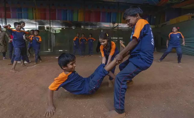 Students play kabbadi, a traditional Indian sport, at the Signal Shala school in Thane near Mumbai, India, April 3, 2025. (AP Photo/Rafiq Maqbool)