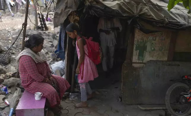 Unnati Pradeep, 11, talks to her mother outside her home in Thane near Mumbai, India, April 9, 2025. (AP Photo/Rafiq Maqbool)