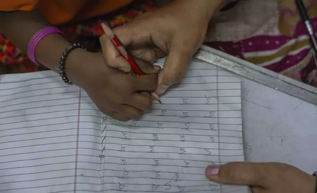 A student studies the Marathi alphabet at the Signal Shala school in Thane near Mumbai, India, April 3, 2025. (AP Photo/Rafiq Maqbool)