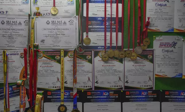 Medals and certificates won by students are displayed on a wall at the Signal Shala school in Thane near Mumbai, India, April 5, 2025. (AP Photo/Rafiq Maqbool)