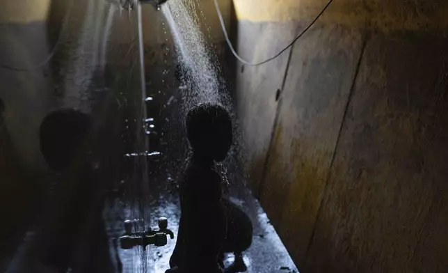 Students shower at the Signal Shala school in Thane near Mumbai, India, April 9, 2025. (AP Photo/Rafiq Maqbool)