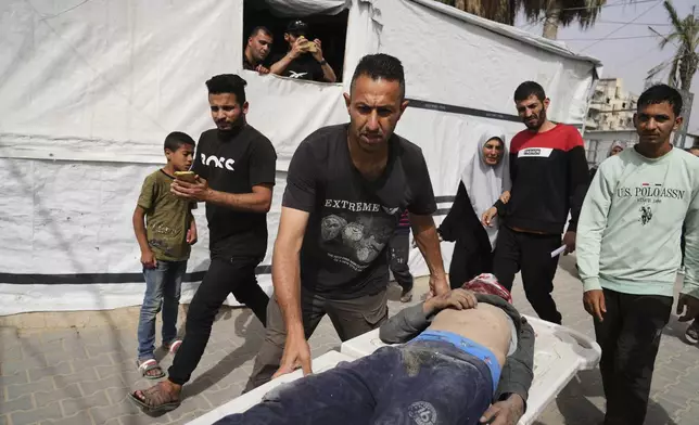 A Palestinian man killed in an Israeli airstrike on central Gaza Strip is brought to Al-Aqsa Hospital in Deir al-Balah, on Saturday, May 17, 2025. (AP Photo/Abdel Kareem Hana)