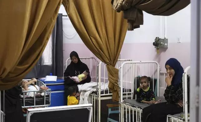 Mayar Al-Arja, 2, right, and 5-month-old Yousef Al-Najjar, both suffering from malnutrition, are cared for by their mothers in a clinic in Nasser Hospital, Khan Younis, Gaza, on Wednesday, May 21, 2025. (AP Photo/Abdel Kareem Hana)