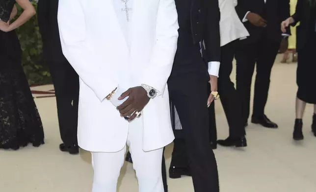 Sean "Diddy" Combs, left, and Cassie Ventura attend The Metropolitan Museum of Art's Costume Institute benefit gala celebrating the opening of the Heavenly Bodies: Fashion and the Catholic Imagination exhibition, May 7, 2018, in New York. (Photo by Evan Agostini/Invision/AP File)