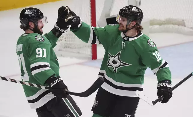 Dallas Stars center Tyler Seguin (91) celebrates his goal with teammate center Sam Steel (18) during the third period in Game 1 of the Western Conference finals in the NHL hockey Stanley Cup playoffs against the Edmonton Oilers, Wednesday, May 21, 2025, in Dallas. (AP Photo/LM Otero)