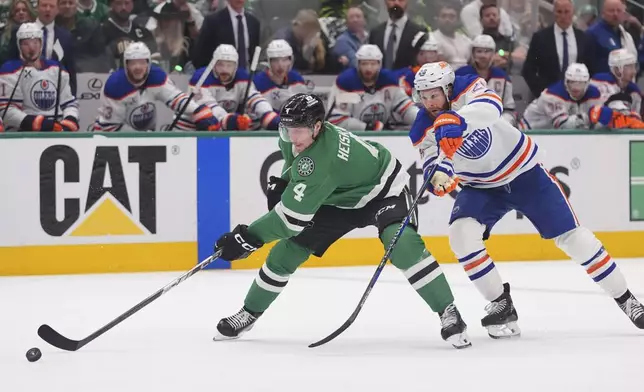 Dallas Stars defenseman Miro Heiskanen (4) skates with the puck against Edmonton Oilers right wing Connor Brown (28) during the second period in Game 1 of the Western Conference finals in the NHL hockey Stanley Cup playoffs Wednesday, May 21, 2025, in Dallas. (AP Photo/LM Otero)