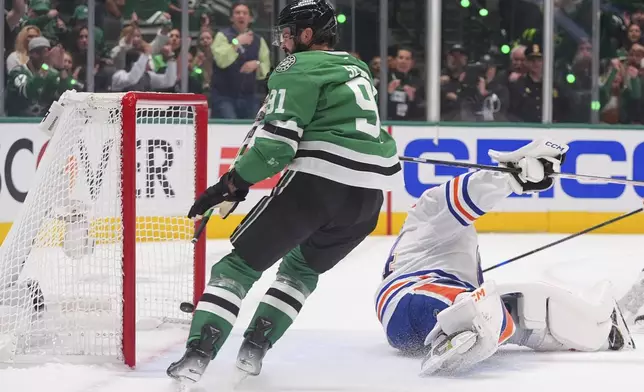 Dallas Stars center Tyler Seguin (91) scores a goal against Edmonton Oilers goaltender Stuart Skinner (74) during the first period in Game 1 of the Western Conference finals in the NHL hockey Stanley Cup playoffs against the Dallas Stars, Wednesday, May 21, 2025, in Dallas. (AP Photo/LM Otero)