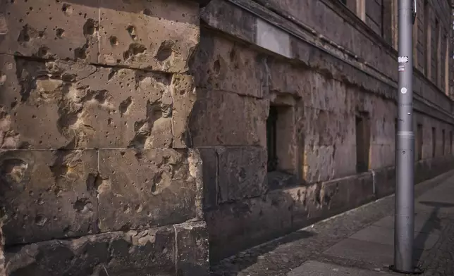 Eighty years after the end of World War II, holes from artillery fire are still visible on the facade of a house in the city center of Berlin, Germany, Friday, May 2, 2025. (AP Photo/Markus Schreiber)