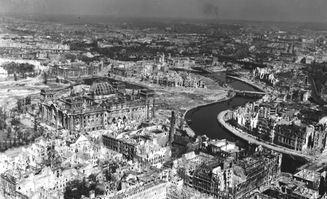 FILE - A view taken from a Cub artillery observation plane on July 10, 1945, shows vast areas of destruction in Berlin, after repeated Anglo-American air raids on the German capital. Seen on the left, center, is the heavily damaged building of the German Reichstag with its distinct cupola, in the background center are the remains of Lehrter Bahnhof, one of the city's train stations. (AP Photo, File)