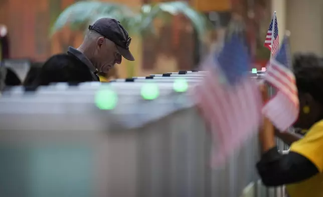 FILE - A person votes in the Nevada primary at a polling place, June 11, 2024, in Henderson, Nev. (AP Photo/John Locher, File)