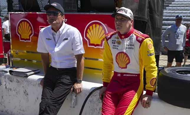 President of Team Penske Tim Cindric, left and driver Josef Newgarden wait for the start of during practice for the Indianapolis 500 auto race at Indianapolis Motor Speedway in Indianapolis, Sunday, May 18, 2025. (AP Photo/Michael Conroy)