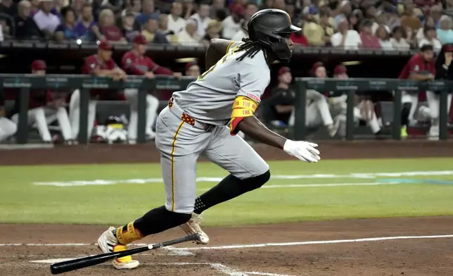 Pittsburgh Pirates' Oneil Cruz (15) hits into a fielders choice with two runs scoring on an error by Arizona Diamondbacks' Jordan Lawlar in the fifth inning during a baseball game, Wednesday, May 28, 2025, in Phoenix. (AP Photo/Rick Scuteri)