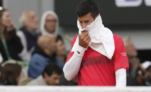 Serbia's Novak Djokovic reacts as he plays Mackenzie McDonald of the U.S. during their first round match of the French Tennis Open, at the Roland-Garros stadium, in Paris, Tuesday, May 27, 2025. (AP Photo/Christophe Ena)