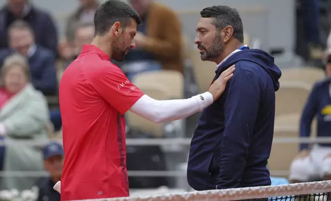 Serbia's Novak Djokovic talks with a judge as he plays Mackenzie McDonald of the U.S. during their first round match of the French Tennis Open, at the Roland-Garros stadium, in Paris, Tuesday, May 27, 2025. (AP Photo/Thibault Camus)