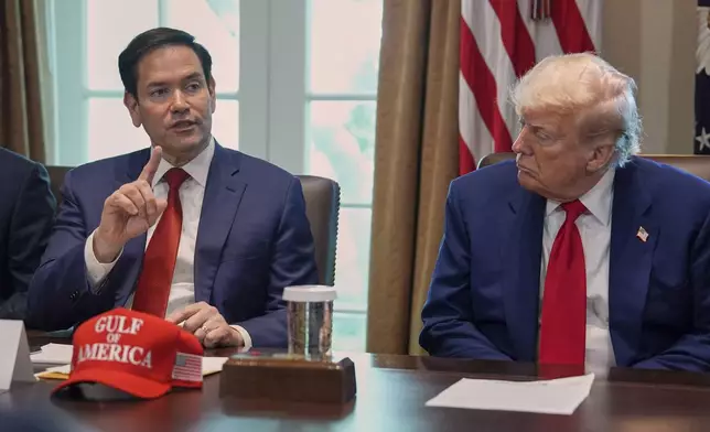 Secretary of State Marco Rubio speaks during a cabinet meeting at the White House, Wednesday, April 30, 2025, in Washington, as President Donald Trump look on. (AP Photo/Evan Vucci)