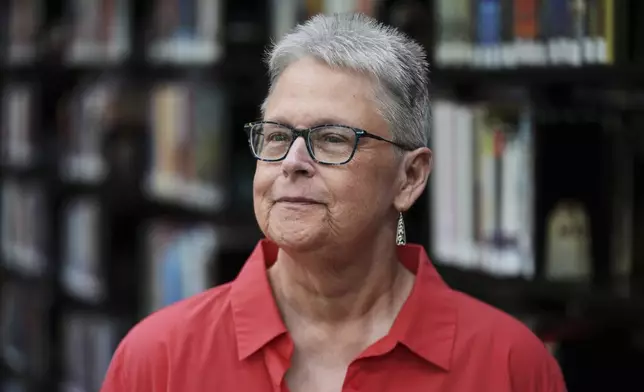 Lisa Brakel poses at the Bedford Branch Library in Temperance, Mich., Tuesday, May 6, 2025. (AP Photo/Paul Sancya)