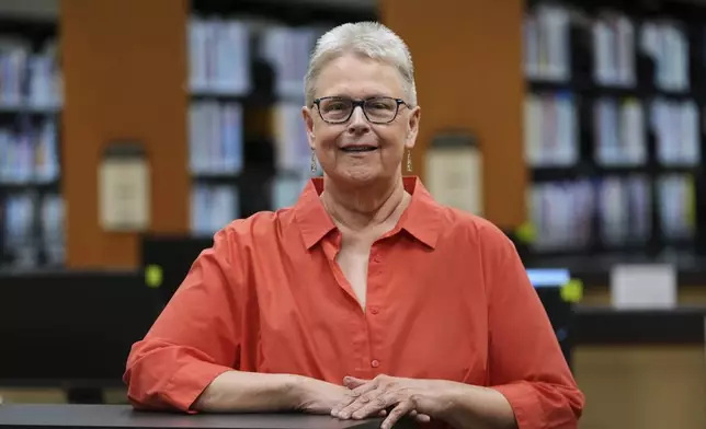 Lisa Brakel poses at the Bedford Branch Library in Temperance, Mich., Tuesday, May 6, 2025. (AP Photo/Paul Sancya)