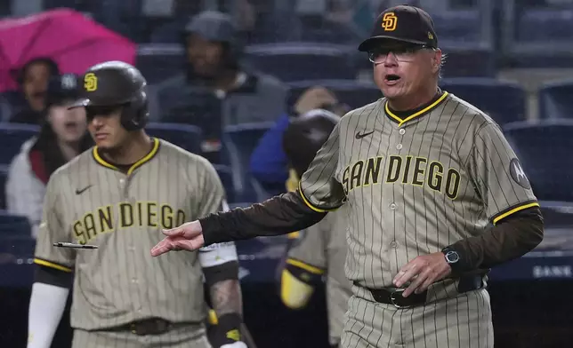 San Diego Padres manager Mike Shildt, right, tosses a pen as he argues with umpire Adrian Johnson during the eighth inning of a baseball game against the New York Yankees Monday, May 5, 2025, in New York. (AP Photo/Pamela Smith)